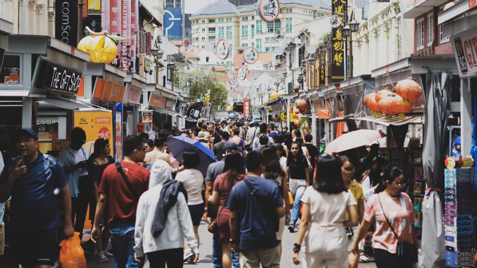 A crowd in a shopping alley