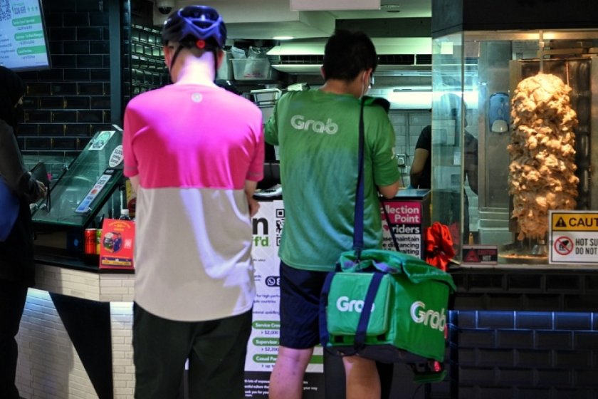 delivery riders lining up at food collection point