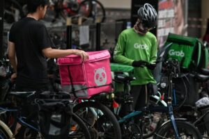 Delivery riders beside bicycles